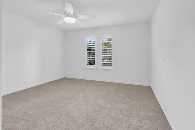 unfurnished room with ceiling fan and carpet flooring