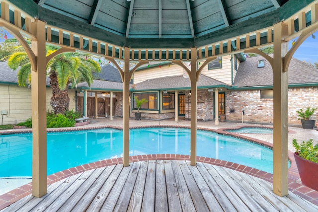 view of swimming pool featuring an in ground hot tub