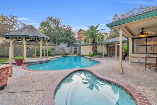 view of swimming pool with a gazebo, ceiling fan, and a patio area