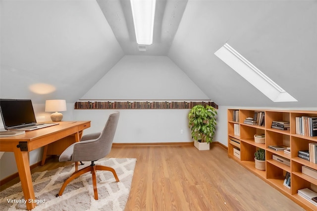 home office with vaulted ceiling and light wood-type flooring