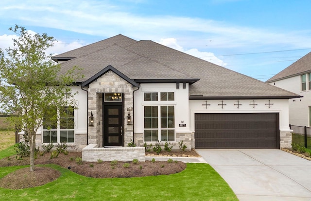 view of front facade with an attached garage, driveway, a shingled roof, and stone siding