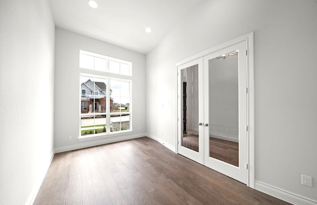 unfurnished room featuring french doors, recessed lighting, baseboards, and wood finished floors
