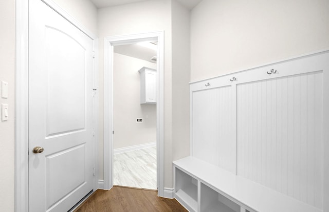 mudroom with baseboards and dark wood-type flooring