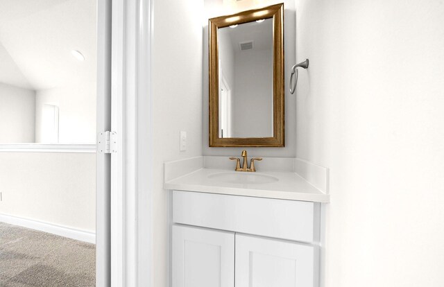 bathroom featuring vanity, baseboards, and visible vents