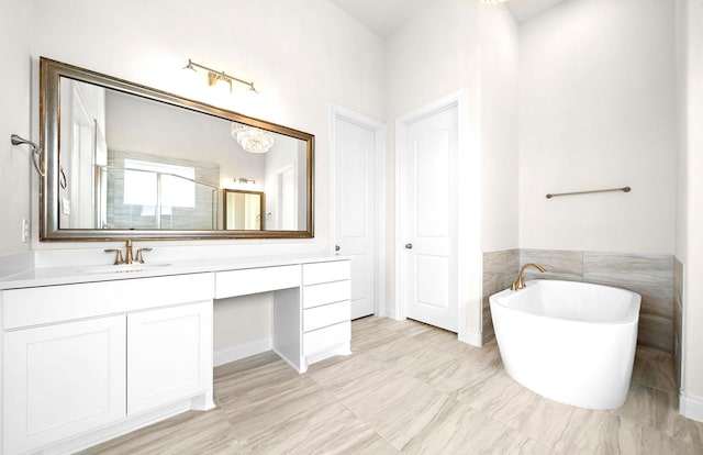 bathroom with an enclosed shower, a chandelier, a soaking tub, and vanity