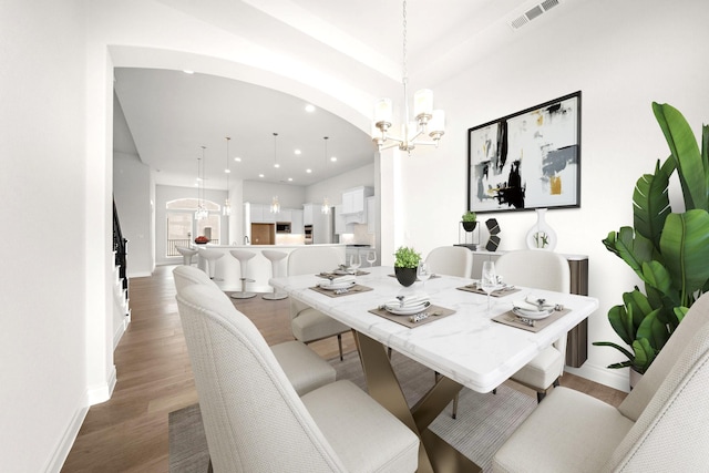 dining area with visible vents, wood finished floors, baseboards, an inviting chandelier, and recessed lighting