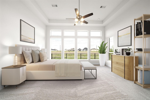 carpeted bedroom featuring visible vents and a raised ceiling
