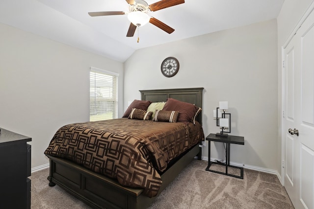 carpeted bedroom with vaulted ceiling and ceiling fan