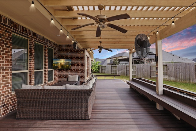 wooden terrace with an outdoor living space