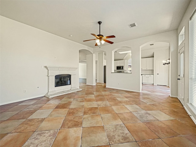 unfurnished living room with ceiling fan