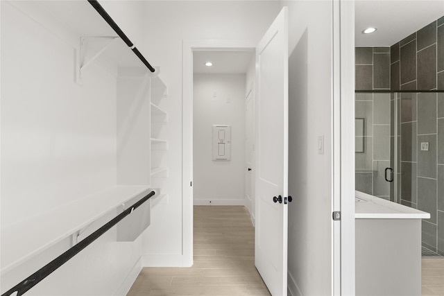 walk in closet featuring light wood-style flooring