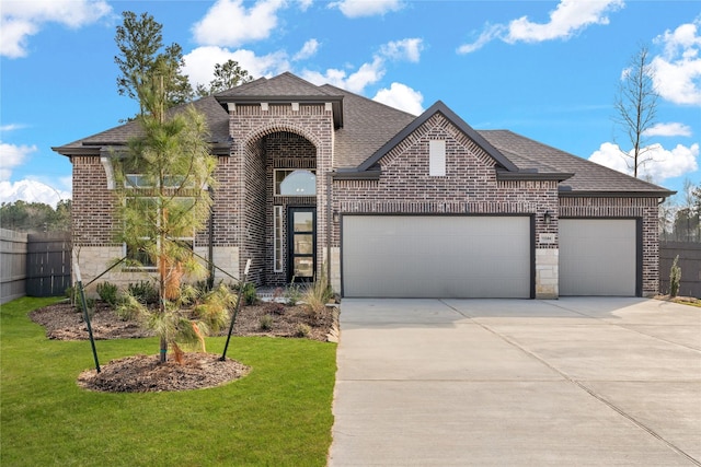 view of front of home with a garage and a front lawn