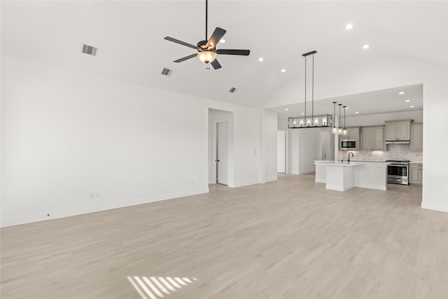 unfurnished living room featuring light wood finished floors, ceiling fan, visible vents, and baseboards