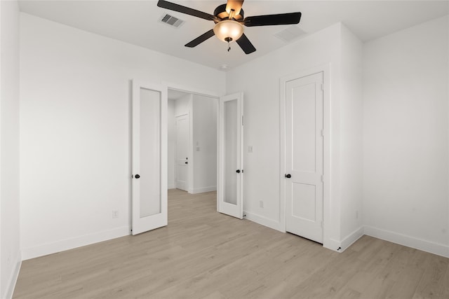 unfurnished bedroom with ceiling fan, french doors, and light hardwood / wood-style floors