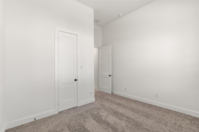 unfurnished bedroom featuring visible vents, baseboards, and light colored carpet