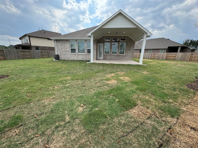 18101 Brennie Bird Ln, Conroe, TX 77302 - rear view of house featuring a patio, brick siding, and cooling unit