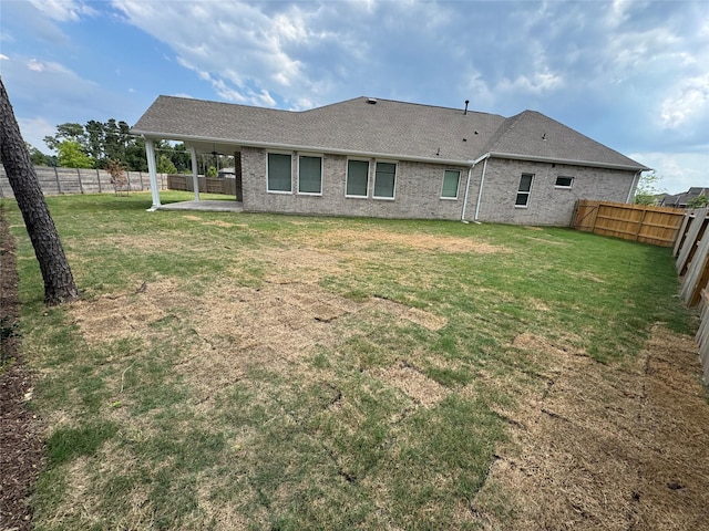 18101 Brennie Bird Ln, Conroe, TX 77302 - rear view of property with a patio, a shingled roof, and brick siding