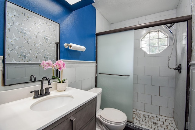 bathroom with walk in shower, a textured ceiling, vanity, tile walls, and toilet