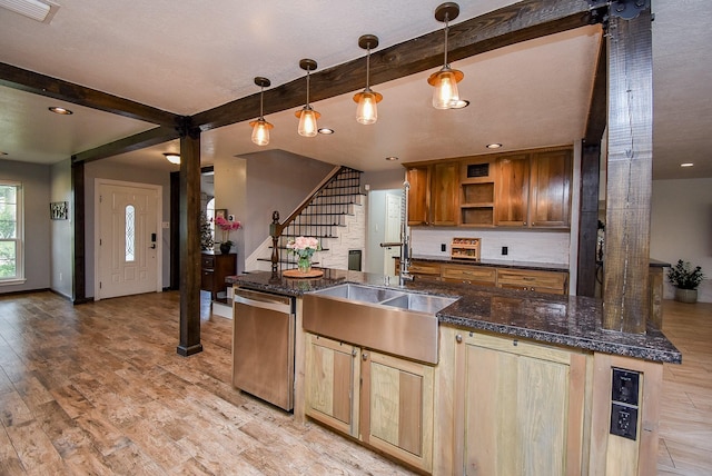 kitchen with beam ceiling, sink, hanging light fixtures, stainless steel dishwasher, and light wood-type flooring