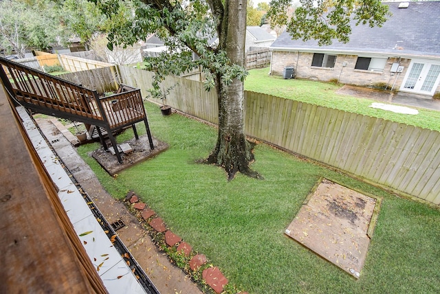 view of yard featuring a wooden deck and cooling unit