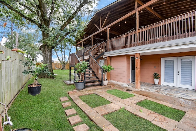 view of yard featuring a patio area and french doors