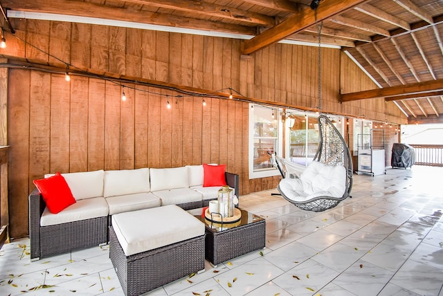 unfurnished living room with lofted ceiling with beams, wood walls, wood ceiling, and a wealth of natural light