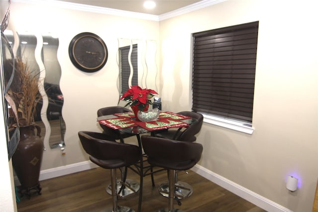 dining room with dark wood-type flooring and ornamental molding