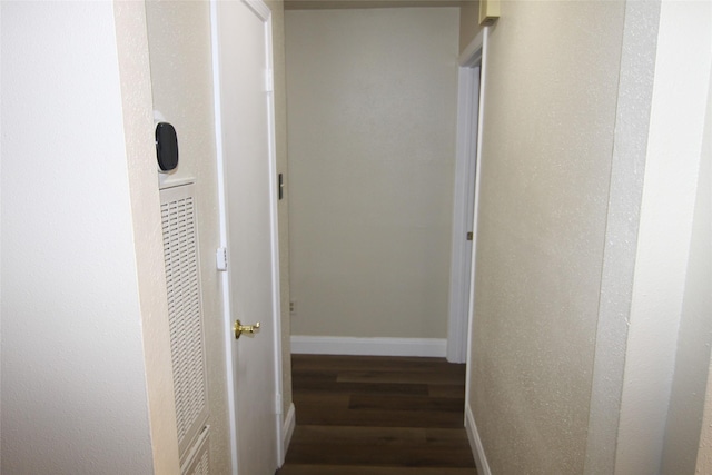 corridor featuring dark hardwood / wood-style flooring