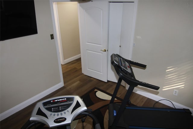 exercise room with dark hardwood / wood-style flooring