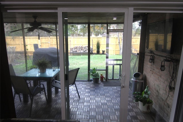 sunroom / solarium with ceiling fan