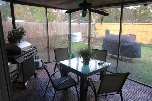 sunroom / solarium featuring ceiling fan and a healthy amount of sunlight