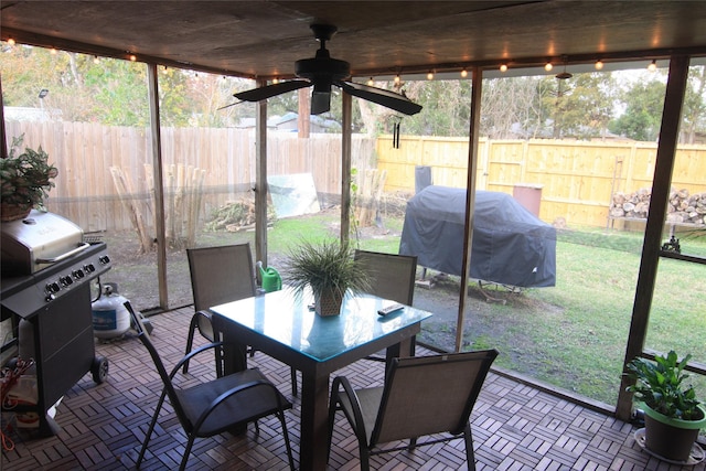 sunroom / solarium with a wealth of natural light and ceiling fan