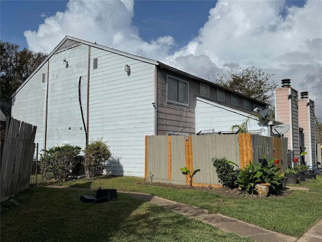 view of home's exterior with a lawn