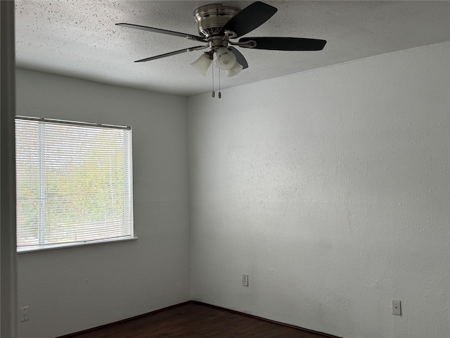 empty room with dark hardwood / wood-style floors and ceiling fan