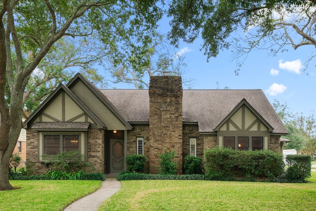 tudor-style house with a front lawn