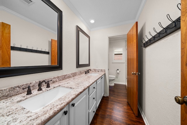 bathroom with vanity, hardwood / wood-style flooring, toilet, and ornamental molding