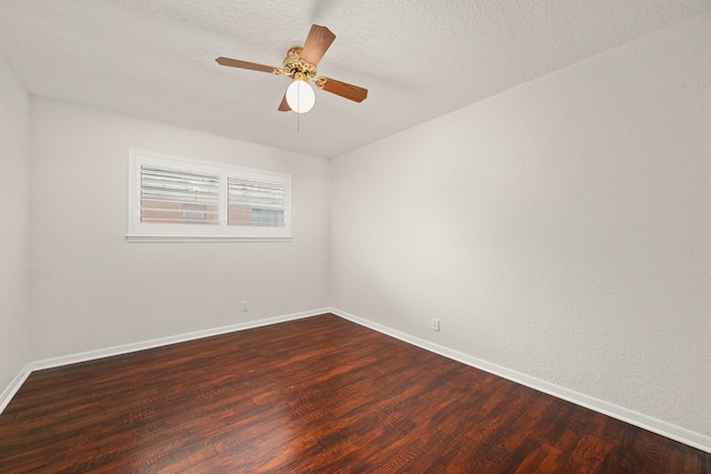 empty room featuring dark hardwood / wood-style floors, ceiling fan, and a textured ceiling