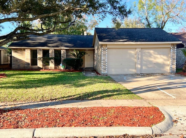 ranch-style home with a front yard and a garage