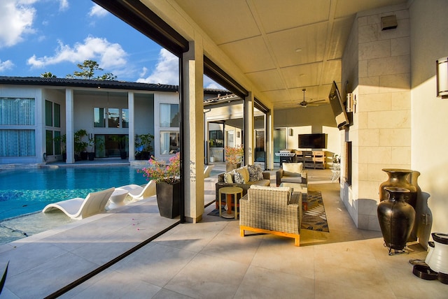 exterior space with an outdoor kitchen, an outdoor hangout area, a patio, and ceiling fan