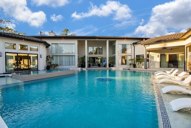 view of swimming pool featuring an in ground hot tub