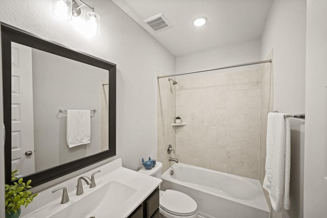 full bathroom featuring vanity, toilet, and tiled shower / bath