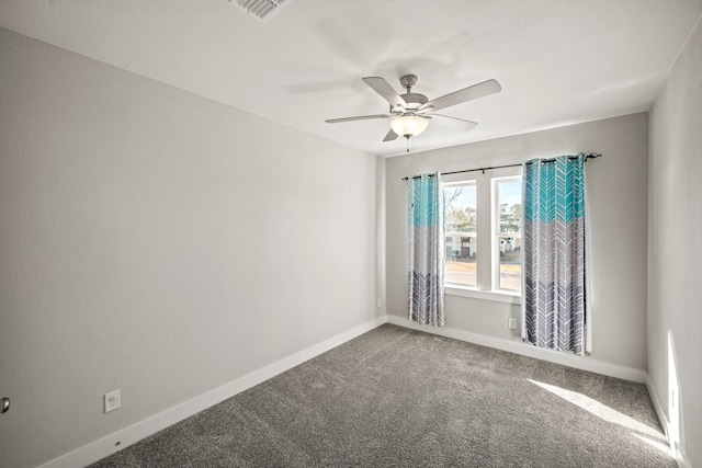 empty room with ceiling fan and carpet floors