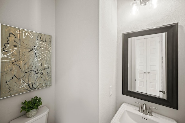 bathroom featuring sink and toilet