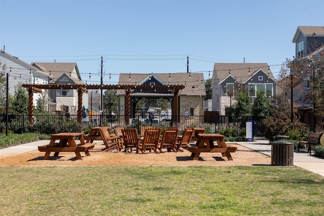 view of home's community featuring a pergola and a yard