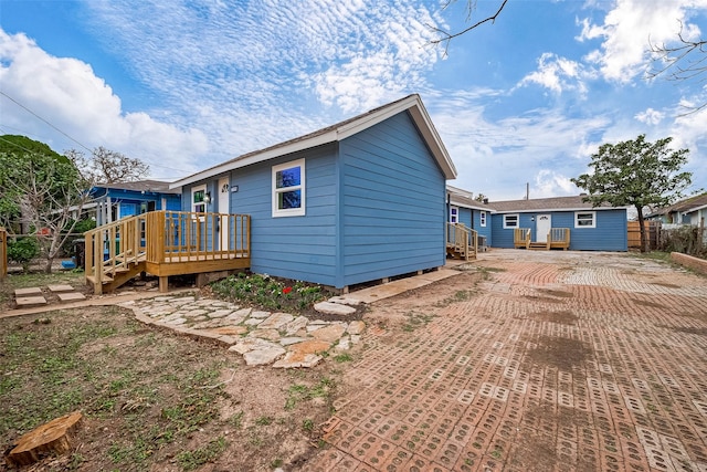 back of house featuring a deck