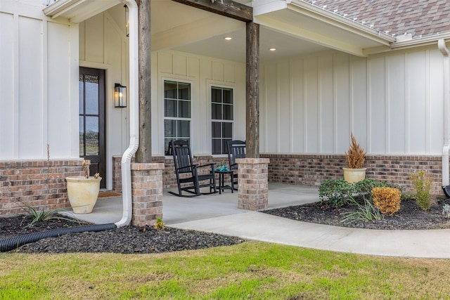 view of exterior entry with a porch