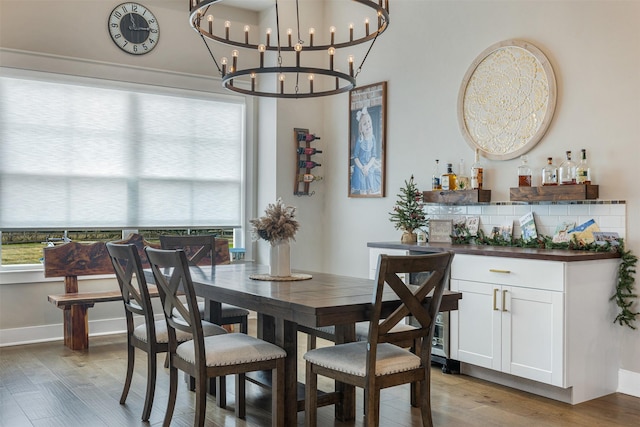 dining room featuring bar area and light wood-type flooring