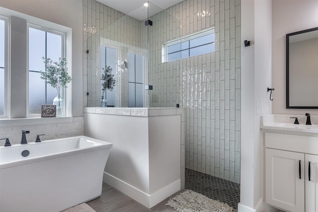 bathroom featuring vanity and shower with separate bathtub