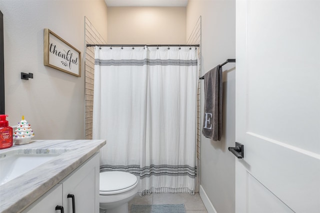 bathroom with vanity, toilet, and tile patterned flooring