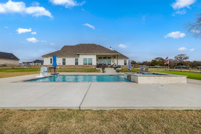 view of pool with an in ground hot tub, a yard, and a patio